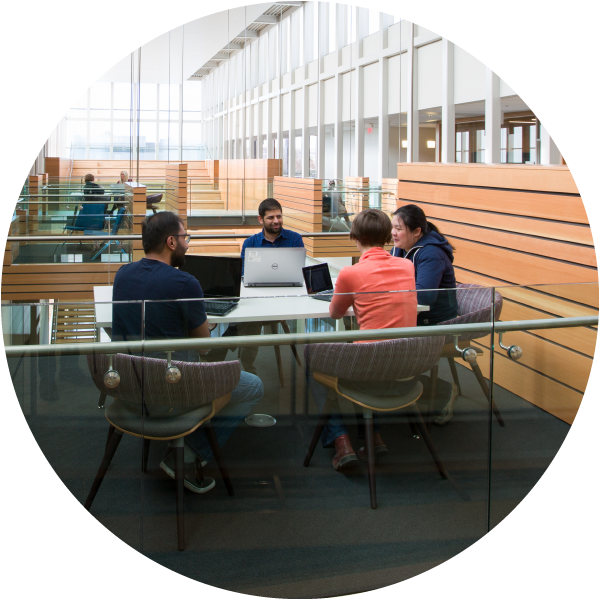 People sitting at a table in the Taylor Institute building