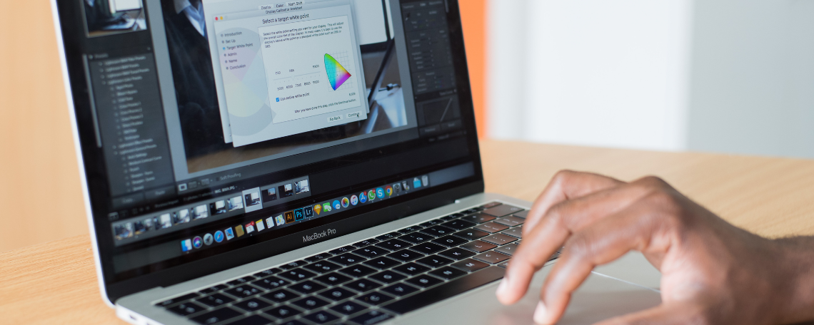 A person's hand on a laptop computer, looking at a presentation.