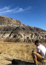 Student working on science in Alberta badlands